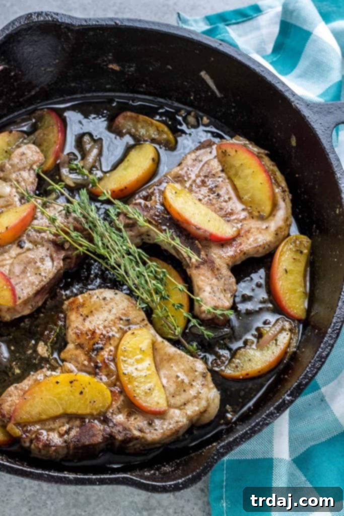 Close-up of golden brown Peach and Dijon Pork Chops with a rich sauce.