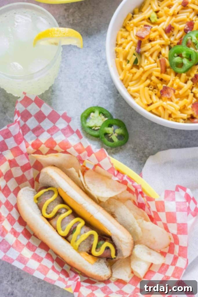 Hasselback hot dog stuffed with jalapeños and wrapped in crispy bacon