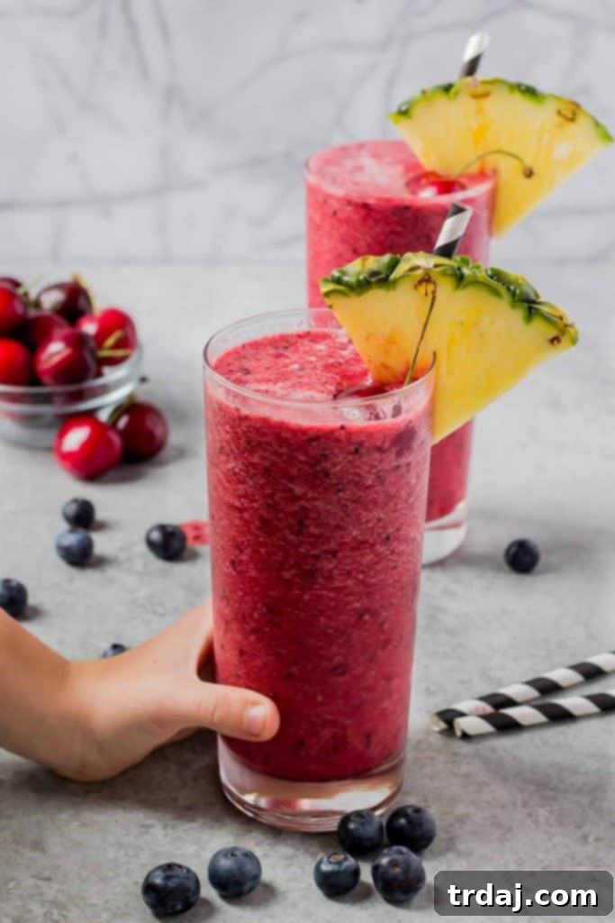 Multiple Glasses of Berry Pineapple Smoothies Served