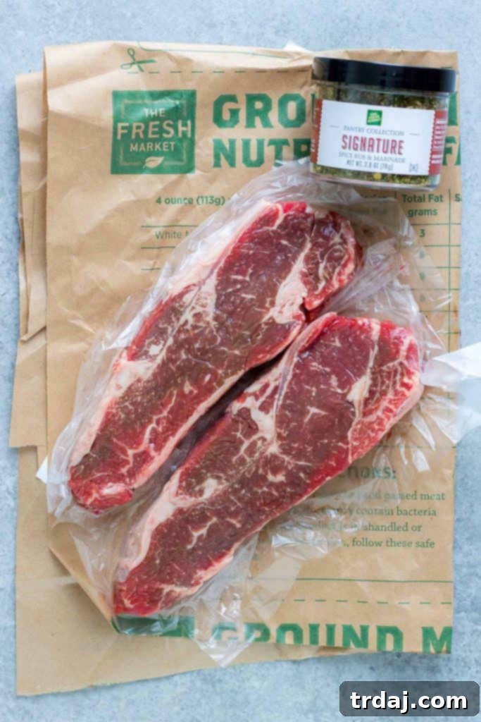 Close-up of a raw NY Strip Steak, showcasing its marbling and quality
