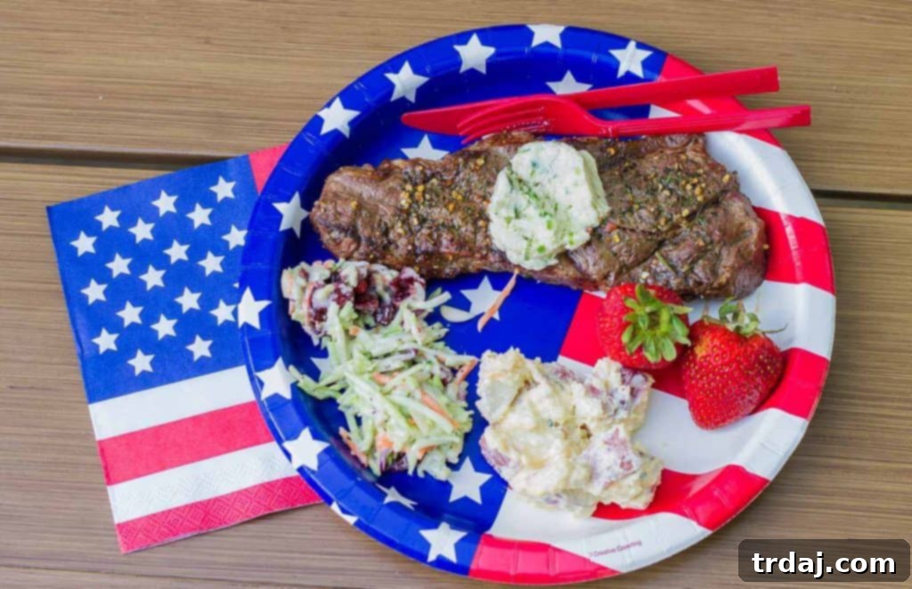 Grilled NY Strip Steak served on a platter, topped with melting compound butter