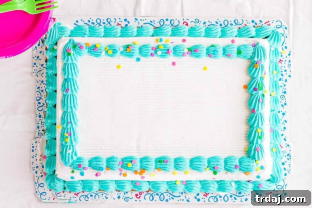 Close-up of the Easy Summer Beach Cake showcasing detailed candy decorations like teddy bears in peach rings and a graham cracker beach.