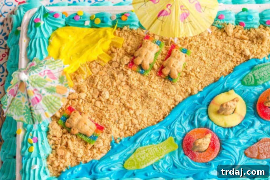 Close-up of a teddy bear cracker relaxing on a candy beach towel on the Easy Summer Beach Cake, surrounded by graham cracker sand.