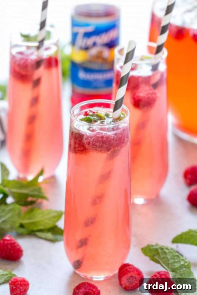 Skinny Raspberry Coconut Mojitos - Mixing ingredients in a large pitcher