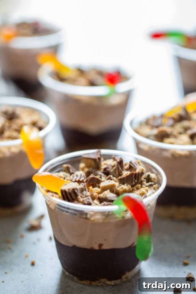 Delicious Peanut Butter Dirt Cups with visible layers of pudding, cookies, and peanut butter cups