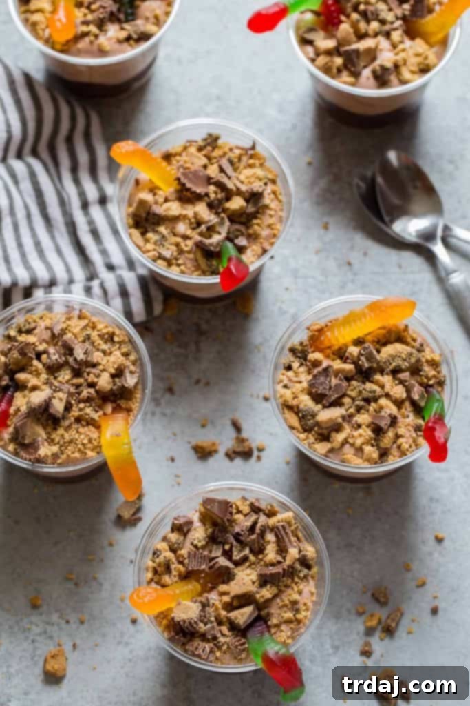 Close-up view of a layered Peanut Butter Dirt Cup in a glass, showcasing its textures