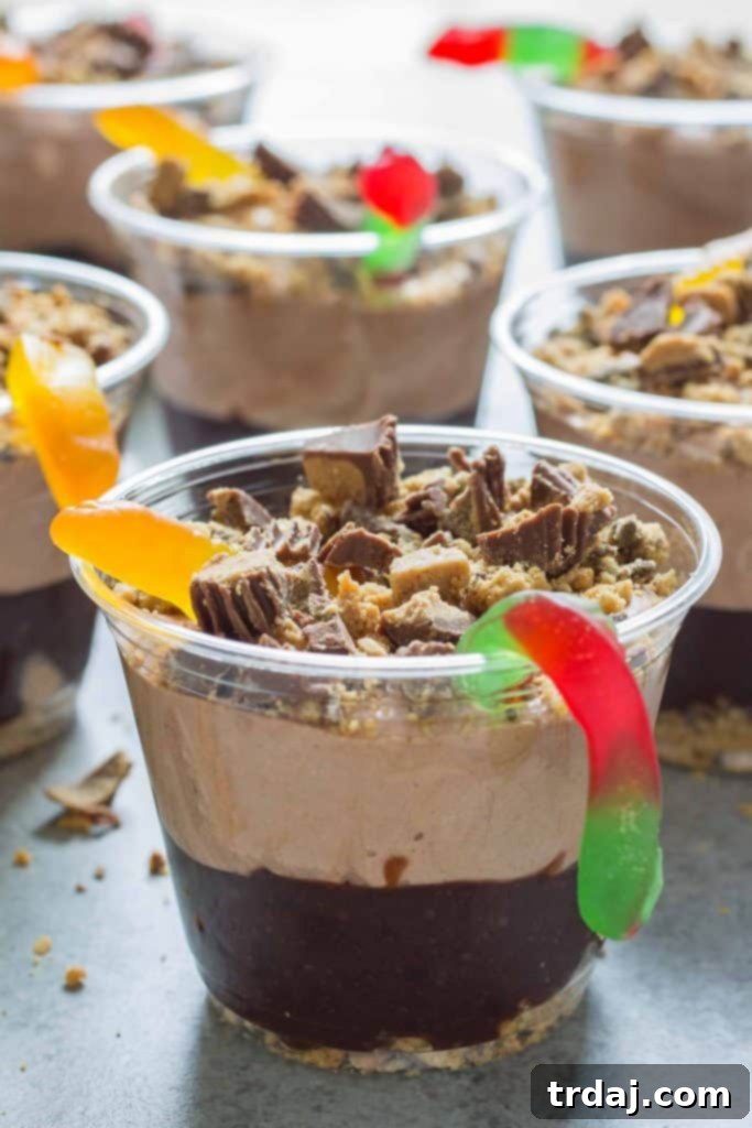 A child's hands reaching for a Peanut Butter Dirt Cup, emphasizing its kid-friendly appeal