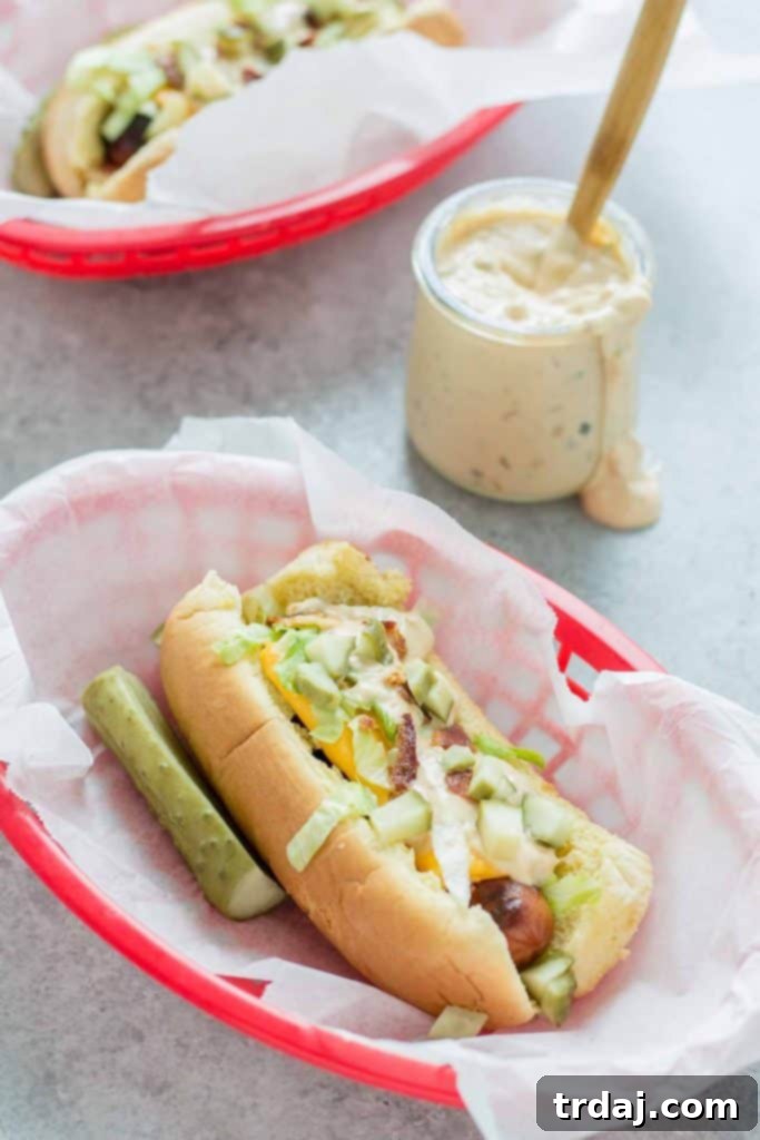 Mac Daddy Hot Dogs - Delicious grilled hot dogs with cheese, lettuce, thousand island, bacon, and pickles.