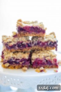 Close-up of a single Mixed Berry Crumble Bar, showing its delicious texture and layers.