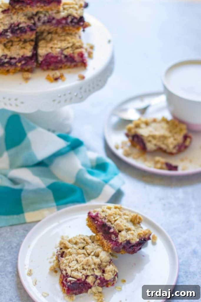 A pan of freshly baked Mixed Berry Crumble Bars, cut into squares and ready for serving.