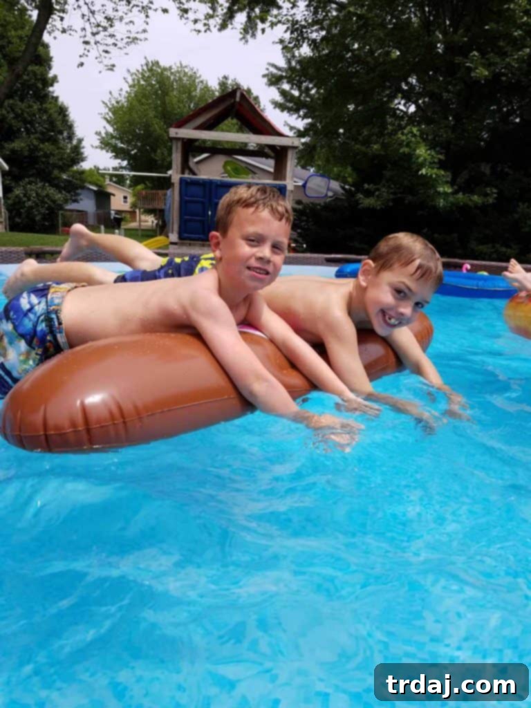 Burgers and hot dogs grilling for a backyard pool party