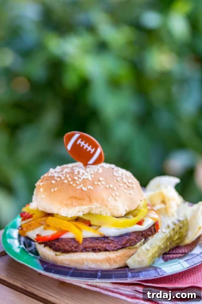 Enjoying a Delicious MorningStar Farms Italian Pepper Burger Hand holding a fully assembled Italian Pepper Burger