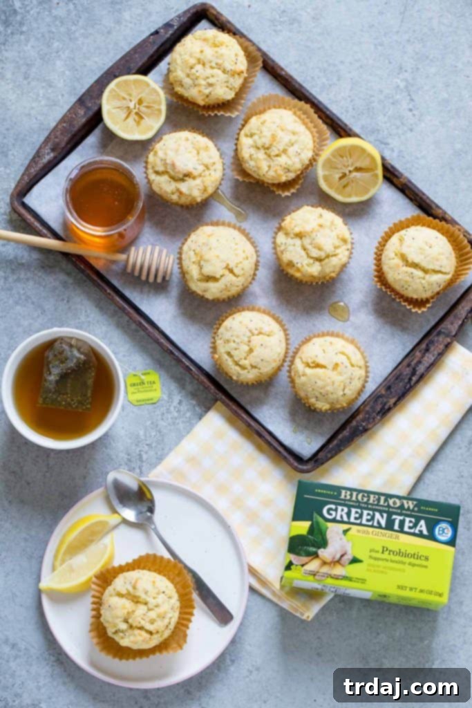 Close-up of a stack of fluffy Citrus Poppyseed Muffins, showcasing their texture