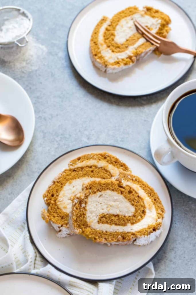 A beautifully sliced Pumpkin Cake Roll with Cookie Butter Filling, perfect for sharing at any festive occasion. Soft, sweet, and bursting with fall flavors.