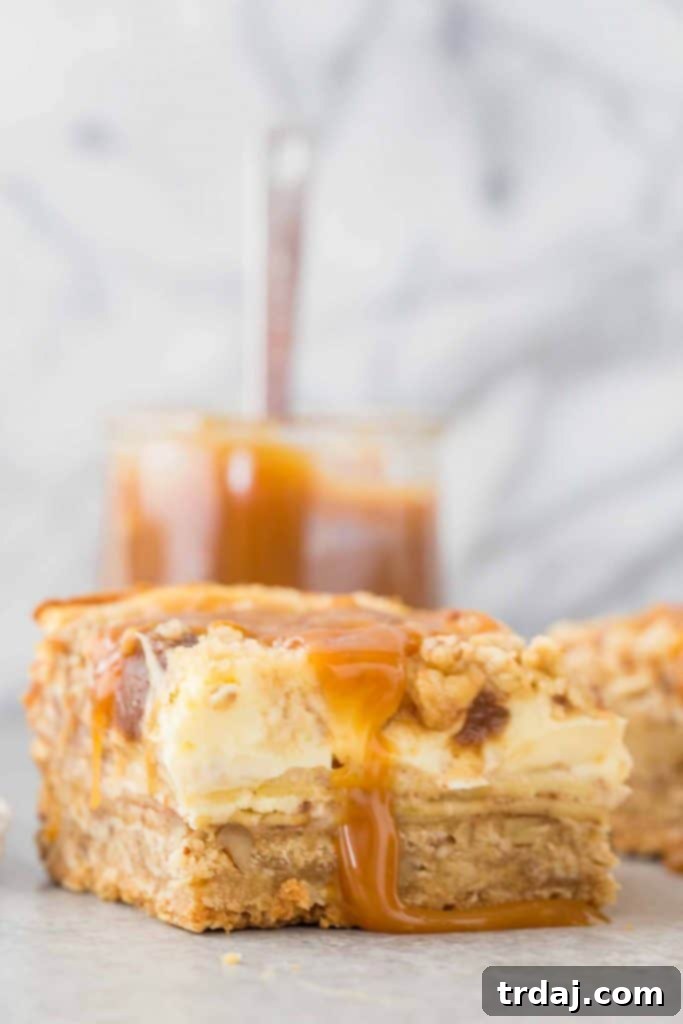Freshly baked Caramel Apple Cheesecake Bars cooling on a wire rack, ready for caramel drizzle.