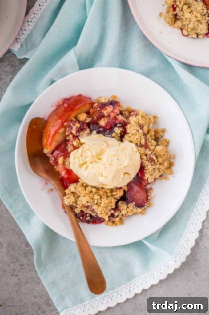 Close-up of baked Apple and Plum Crumble with golden topping.