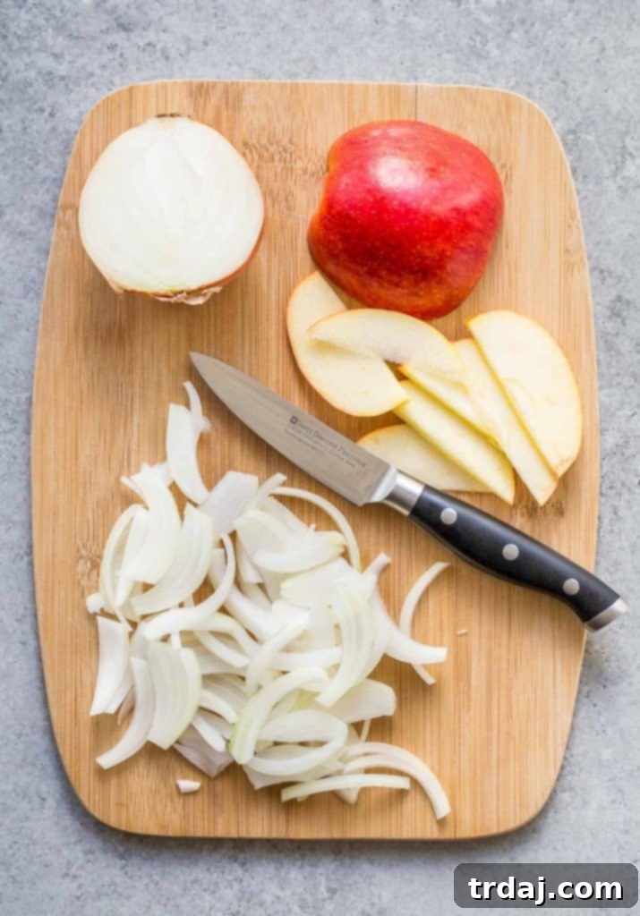 Hands thinly slicing an onion with a Swiss Diamond Paring Knife, preparing for caramelized onions, a key ingredient for Apple, Bacon and Caramelized Onion Pizza.