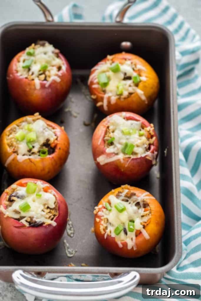 Stuffed Apples with Cheddar and Sausage, showcasing a golden-brown apple stuffed with savory filling and melted cheddar