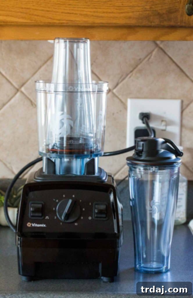 Aromatic spices combine with almonds to create a delicious Apple Chai Almond Butter that's perfectly spreadable on anything from apples to bread and everything in between! Close-up of creamy Apple Chai Almond Butter in a jar