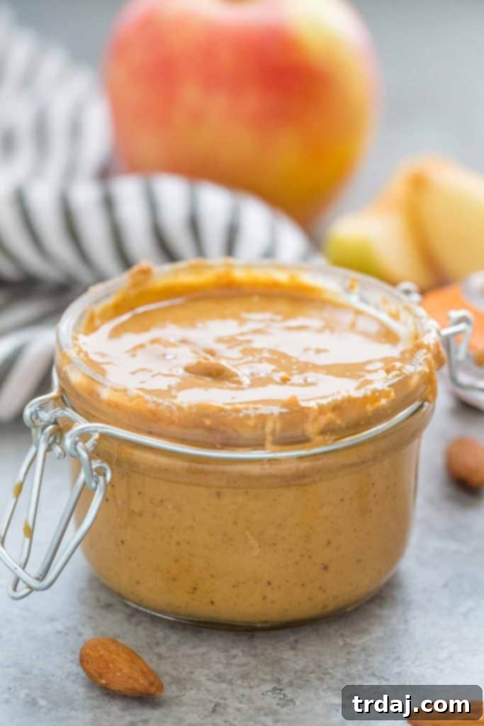 Aromatic spices combine with almonds to create a delicious Apple Chai Almond Butter that's perfectly spreadable on anything from apples to bread and everything in between! Apple Chai Almond Butter spread on a toast with apple slices