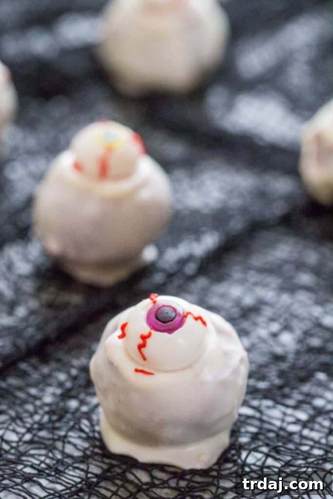 Eyeball Cakes Balls - A Halloween treat of moist cake dipped in white chocolate with a gummy eyeball.