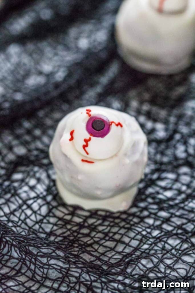 Eyeball Cakes Balls - Three finished cake balls with gummy eyeballs, ready for a Halloween celebration.