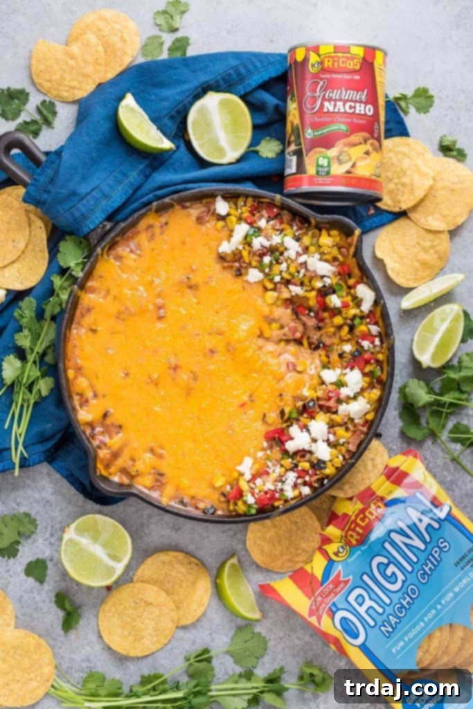 Creamy Mexican Street Corn Queso in a cast iron skillet, ready to serve
