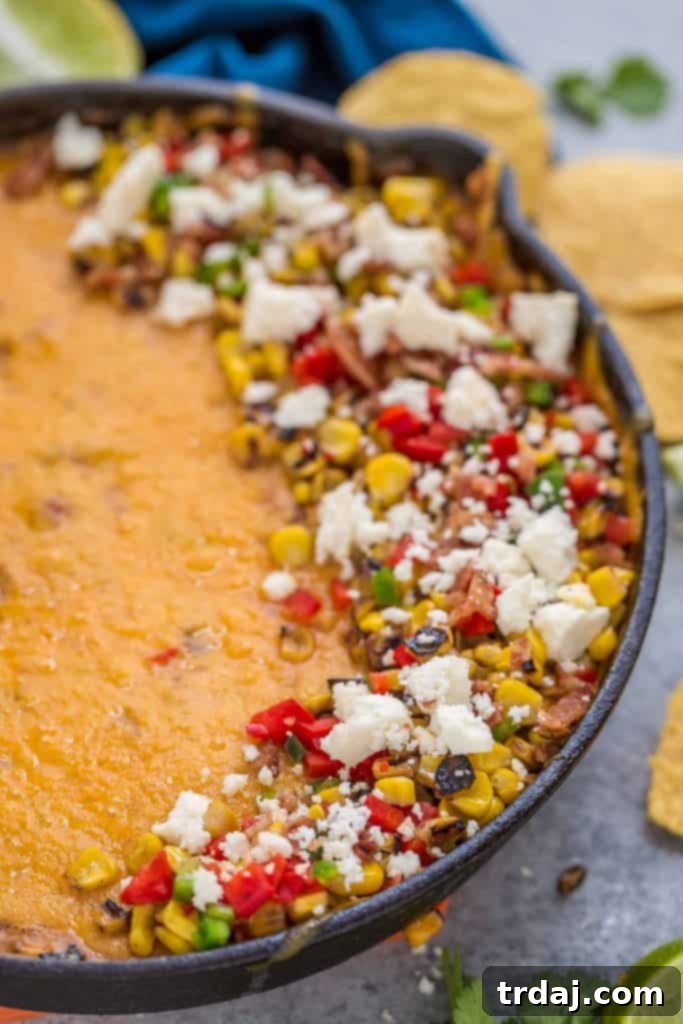 Close-up of Mexican Street Corn Queso, showcasing its rich texture and colorful ingredients