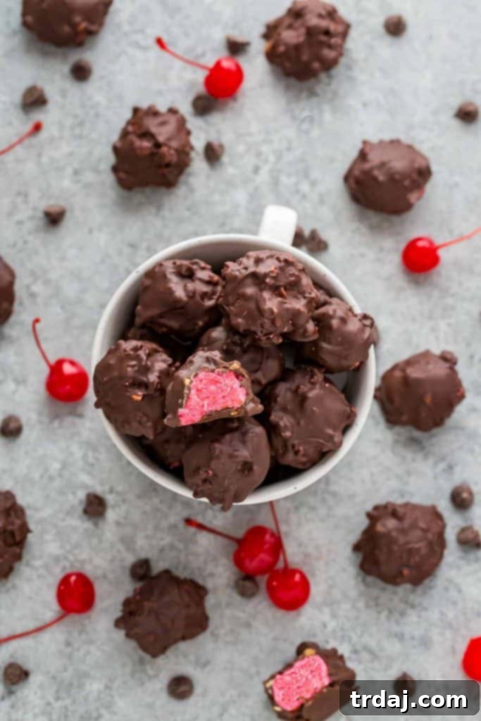 Cherry Mash Truffles presented beautifully in a mug, surrounded by fresh cherries and festive candies