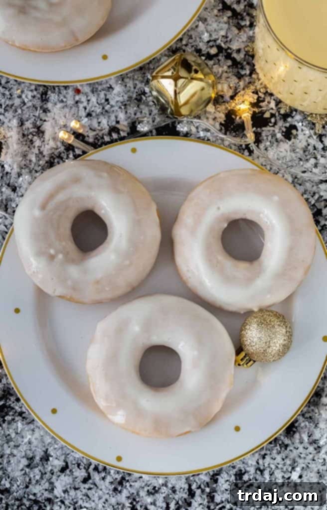 Eggnog Cinnamon Roll Donuts stacked on a white plate