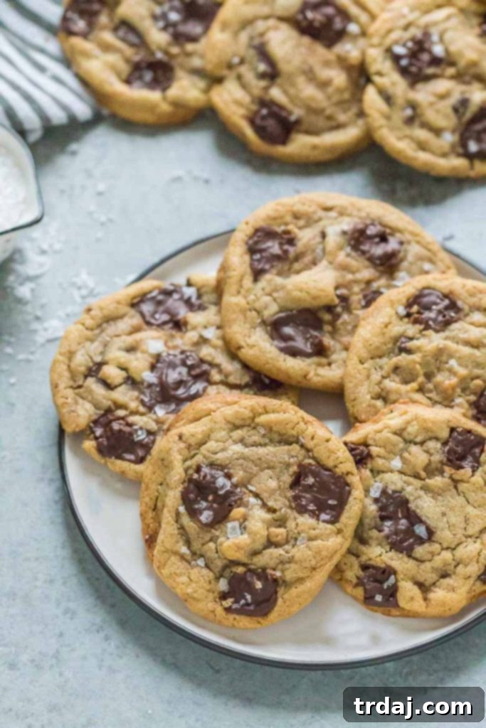 Close-up of golden brown Tahini Toffee Chocolate Chip Cookies on a baking sheet