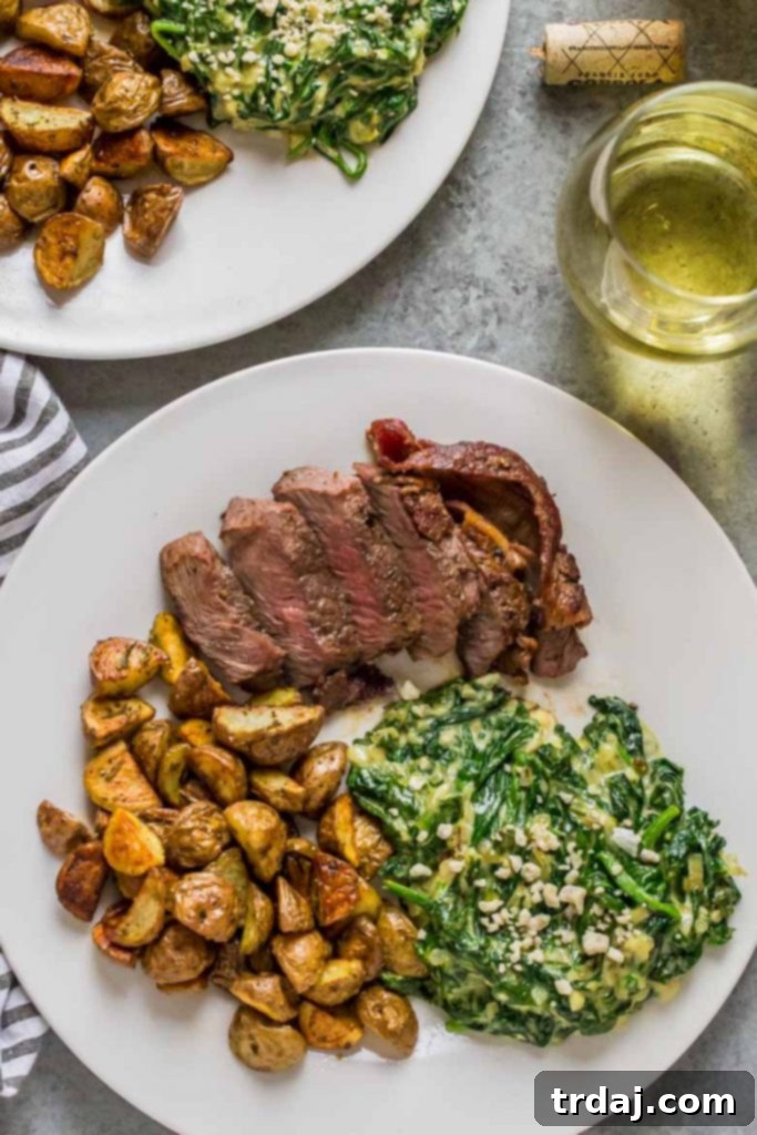 Gourmet Steakhouse Dinner for Two with filet mignon, rosemary potatoes, and creamed spinach arranged artfully