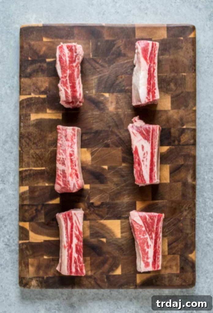 Uncooked beef short ribs seasoned and ready for searing