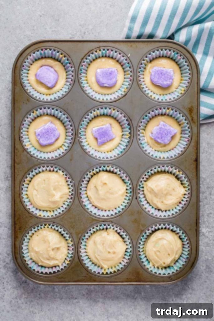 Placing frozen PEEPS into cupcake batter