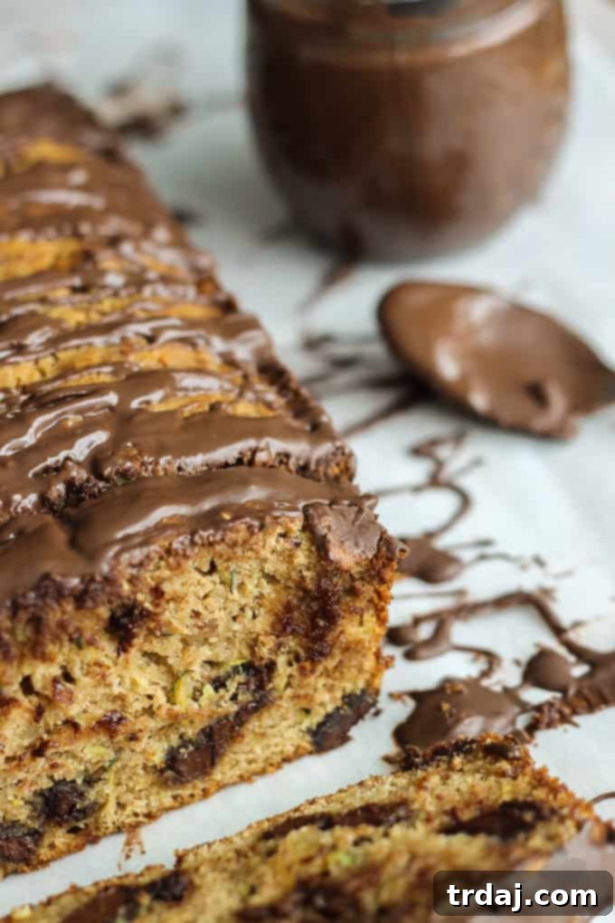 Deliciously moist, intensely chocolatey, and flavorful Chocolate Chunk Zucchini Bread with warm spices and chocolate drizzle, perfect for any occasion.