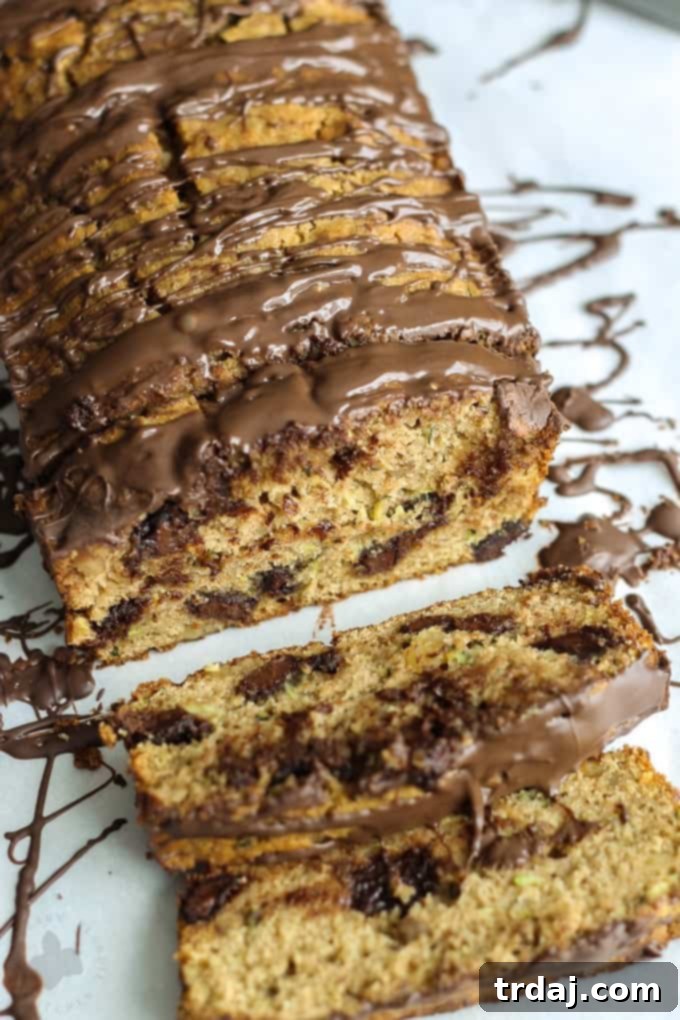 A beautifully styled loaf of Chocolate Chunk Zucchini Bread, showcasing its golden crust and inviting texture, ready to be sliced.