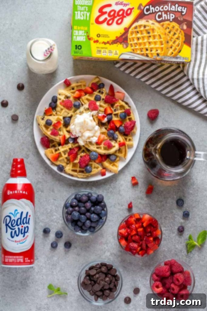 Completed plate of Fruity Breakfast Waffle Nachos with various fruits and whipped cream