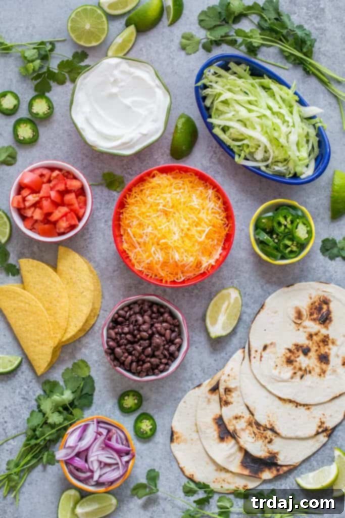 A festive build-your-own taco bar setup with various ingredients