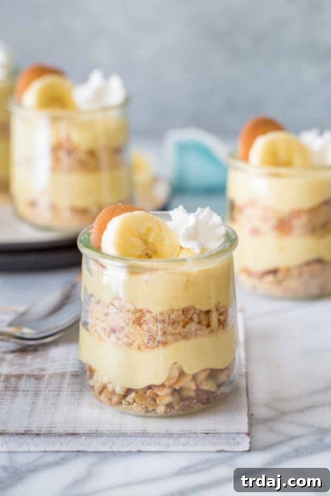 Homemade banana pudding simmering in a red enameled cast iron casserole dish.