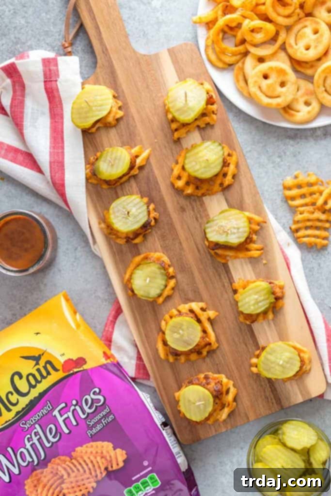 These Nashville Hot Chicken Waffle Bites are spicy, crispy and super simple to put together for all your appetizer needs! Finished platter of Nashville Hot Chicken Waffle Bites with pickles, ready to be enjoyed.