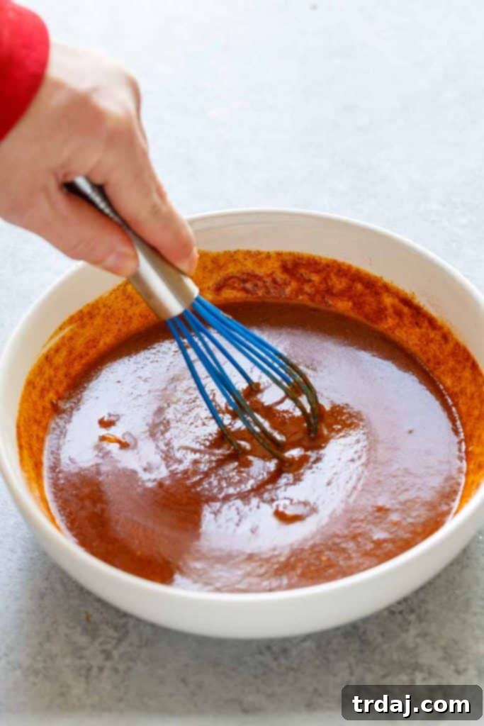 Nashville Hot Chicken Waffles Bites Sauce Whisking ingredients to create the Nashville Hot Chicken Waffle Bites sauce.