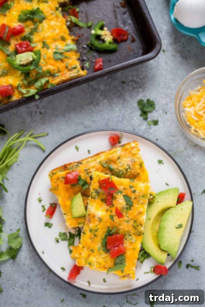 This Sheet Pan Mexican Frittata is packed full of delicious Mexican flavors and is perfect for a crowd or meal prep! Close-up of a bubbling Sheet Pan Mexican Frittata, showcasing the chorizo, beans, and cheese