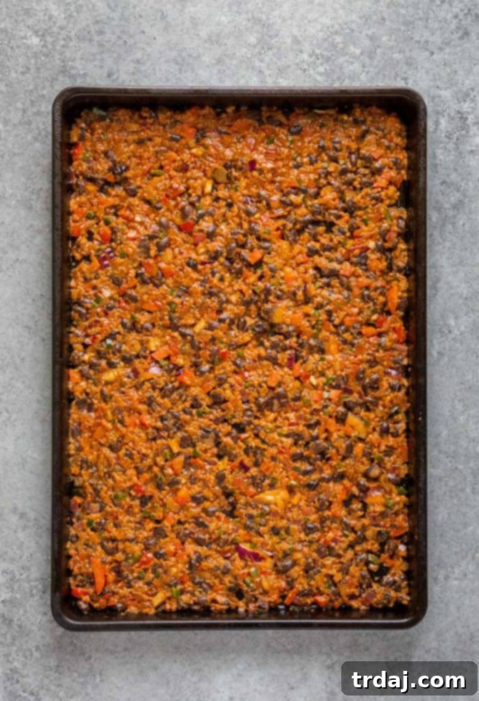 This Sheet Pan Mexican Frittata is packed full of delicious Mexican flavors and is perfect for a crowd or meal prep! Chorizo, bell pepper, onion, and black bean mixture spread evenly on the bottom of a sheet pan