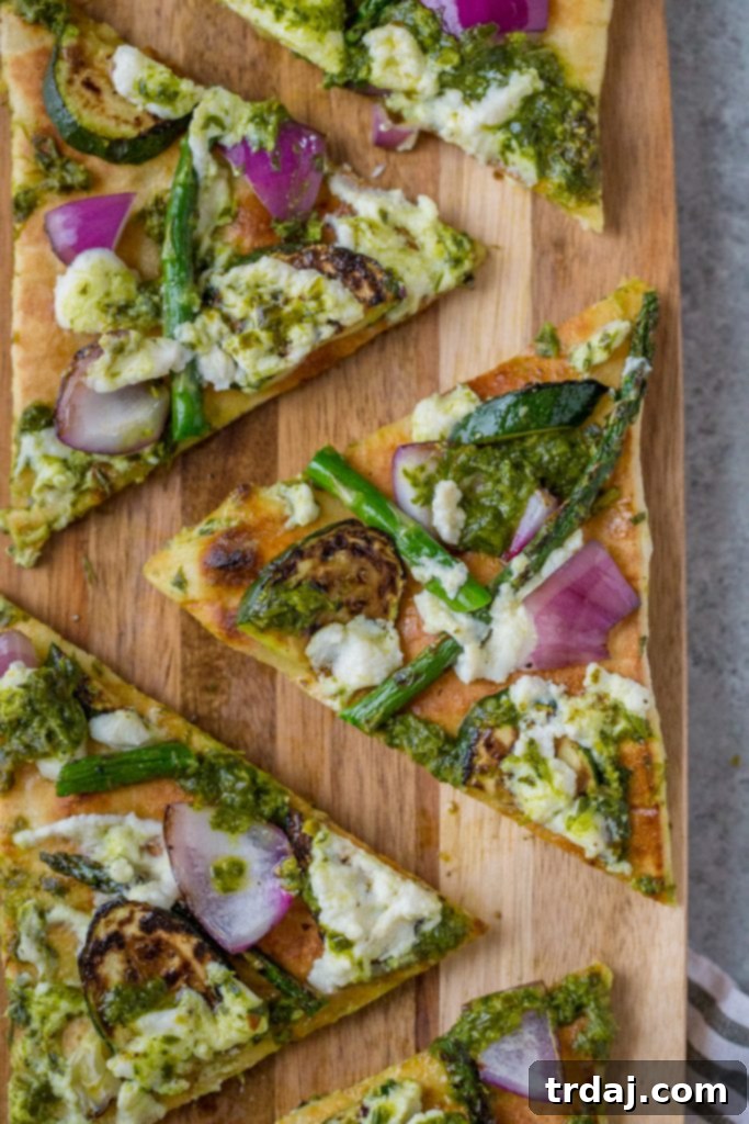 A close-up of gourmet Grilled Vegetable Flatbreads, artfully arranged with fresh ingredients.