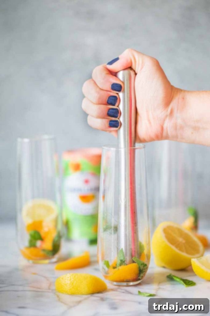 Muddling peaches and basil for mojito mocktail