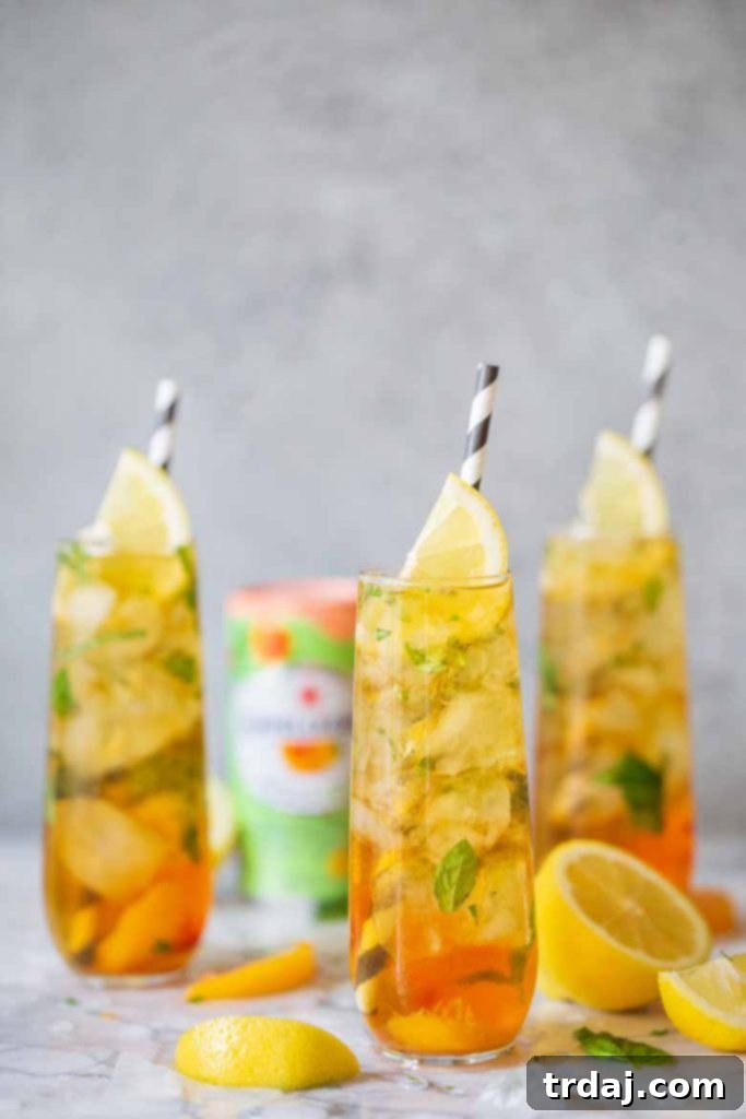 Finished Peach Basil Mojito Mocktail with lemon and paper straw