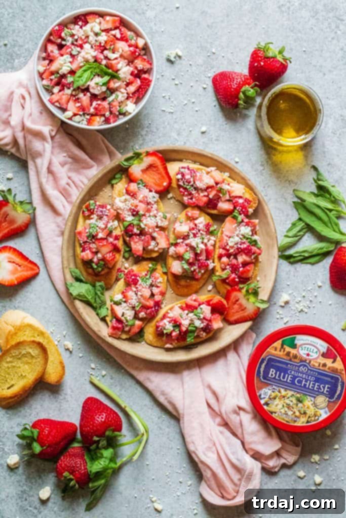Close-up of Strawberry Blue Cheese Bruschetta on toasted bread with basil garnish