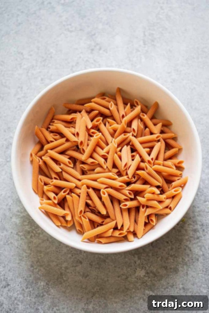 Dry red lentil pasta before cooking, showing its vibrant color