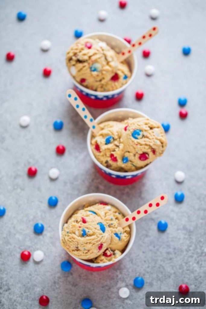 Patriotic Edible Cookie Dough in a red cup, garnished with sprinkles, showcasing a delicious no-bake treat perfect for celebrations.