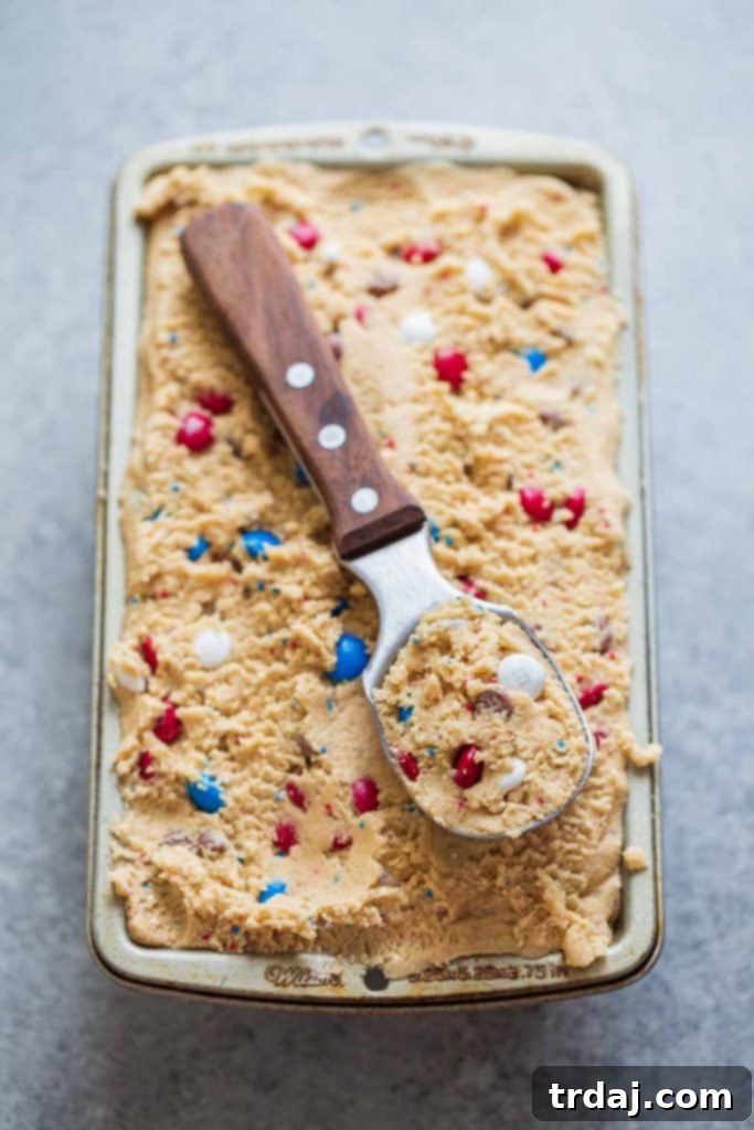 A scoop full of Patriotic Edible Cookie Dough, ready to be enjoyed as a safe and delicious no-bake dessert.